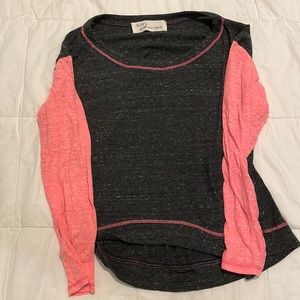 Thin long sleeve top with pink sleeves.